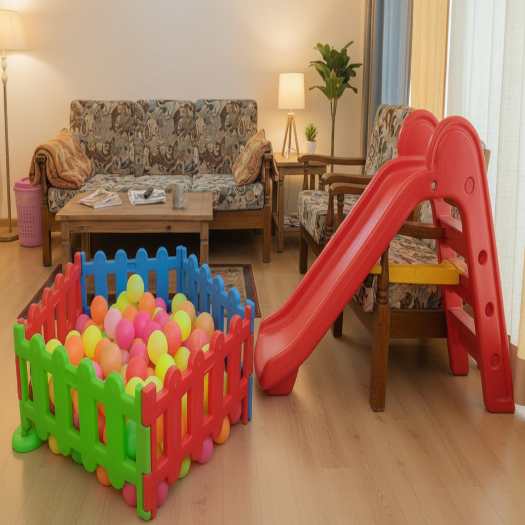 Colorful play set with a slide and ball pit in a living room.