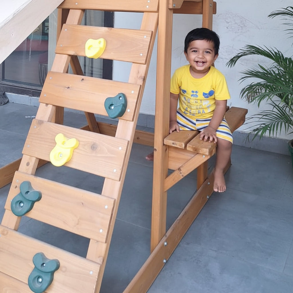Wooden playhouse with a ladder and chalkboard wall outdoors